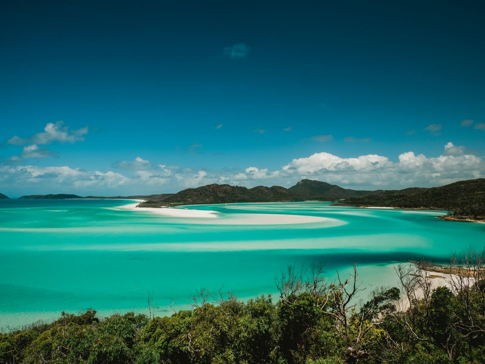 Turquoise water swirling around the white sand of Hill Inlet in the Whitsundays