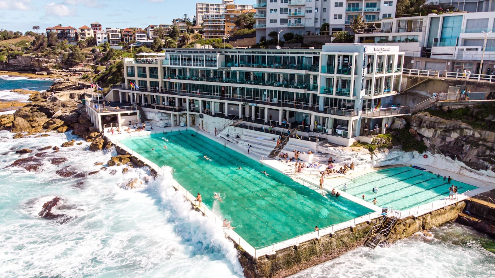 Waves crashing over the Bondi Icebergs ocean pool on Sydney's coast