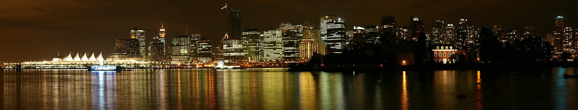 Vancouver's downtown towers glowing over the harbour at night