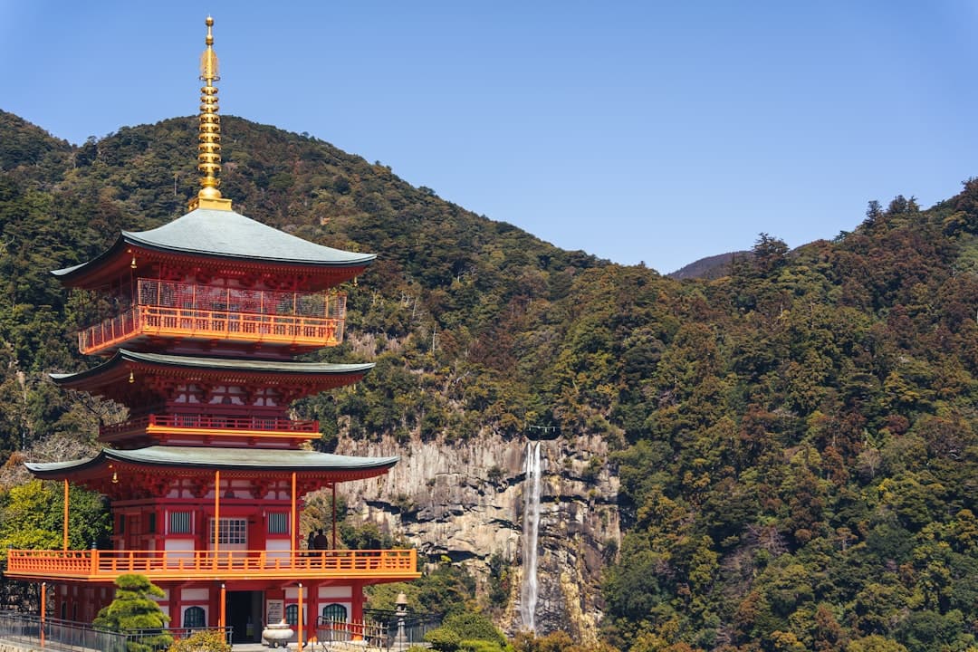 Seiganto-ji's vermilion pagoda with Nachi Falls plunging beside it