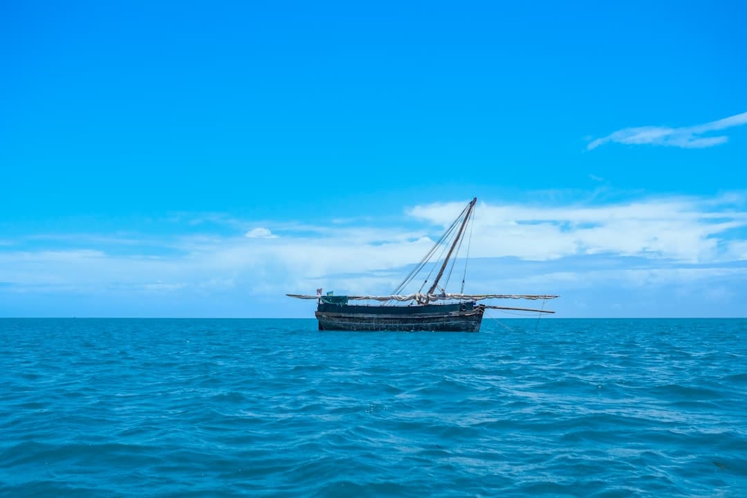 A dhow sailing across turquoise Indian Ocean shallows