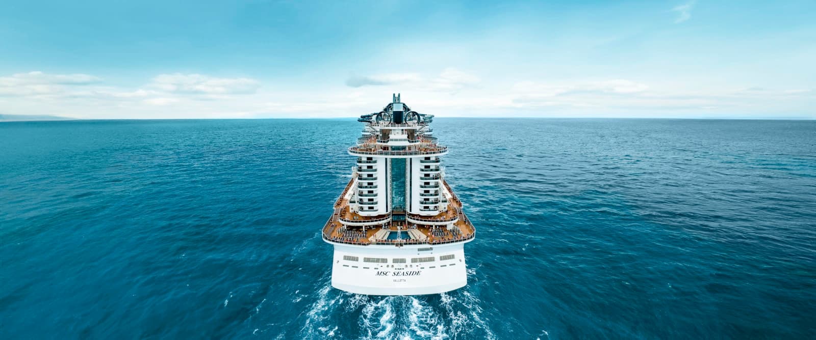 A cruise ship heading out across open blue water