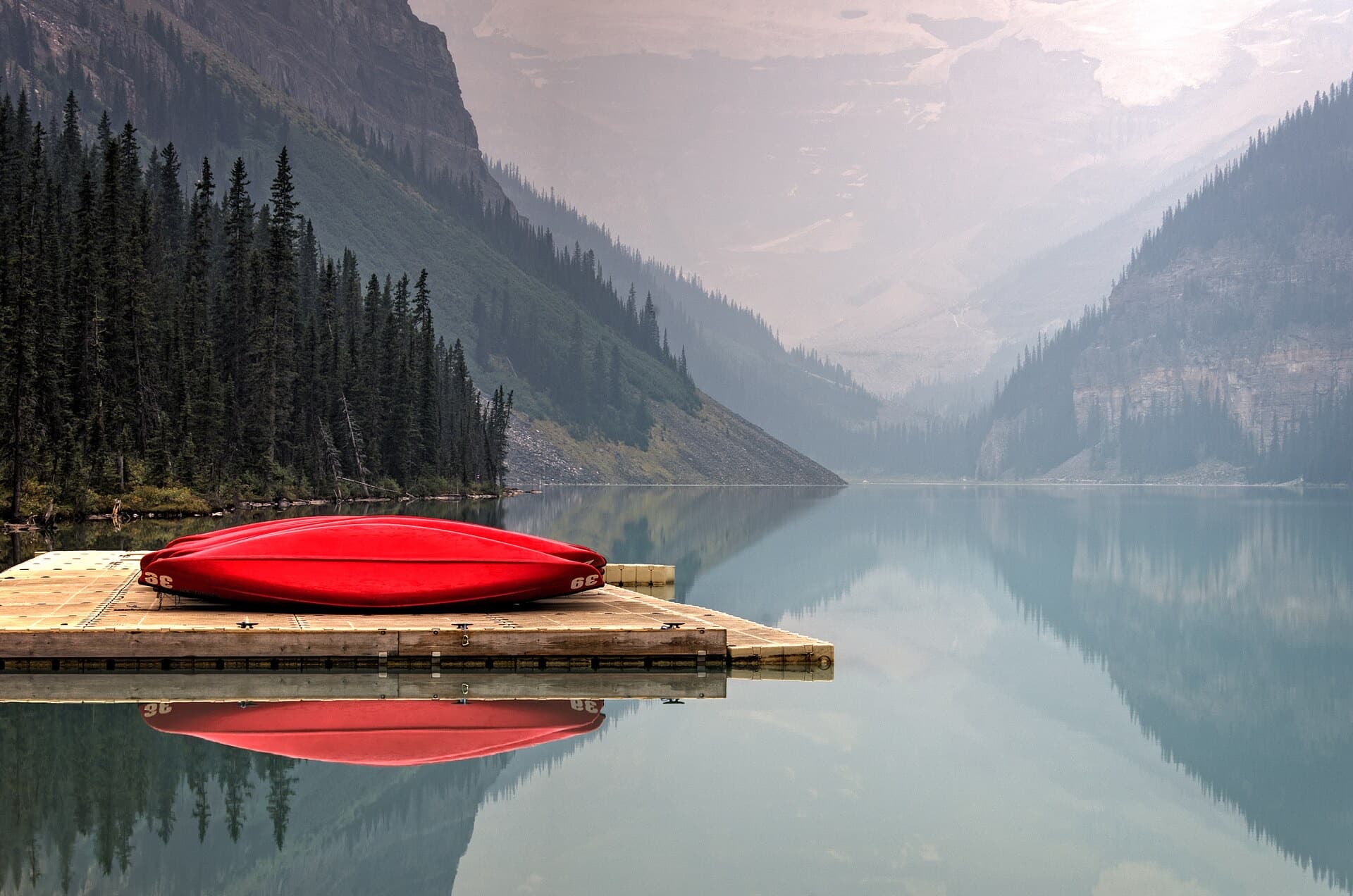 A red canoe resting on the dock at Lake Louise