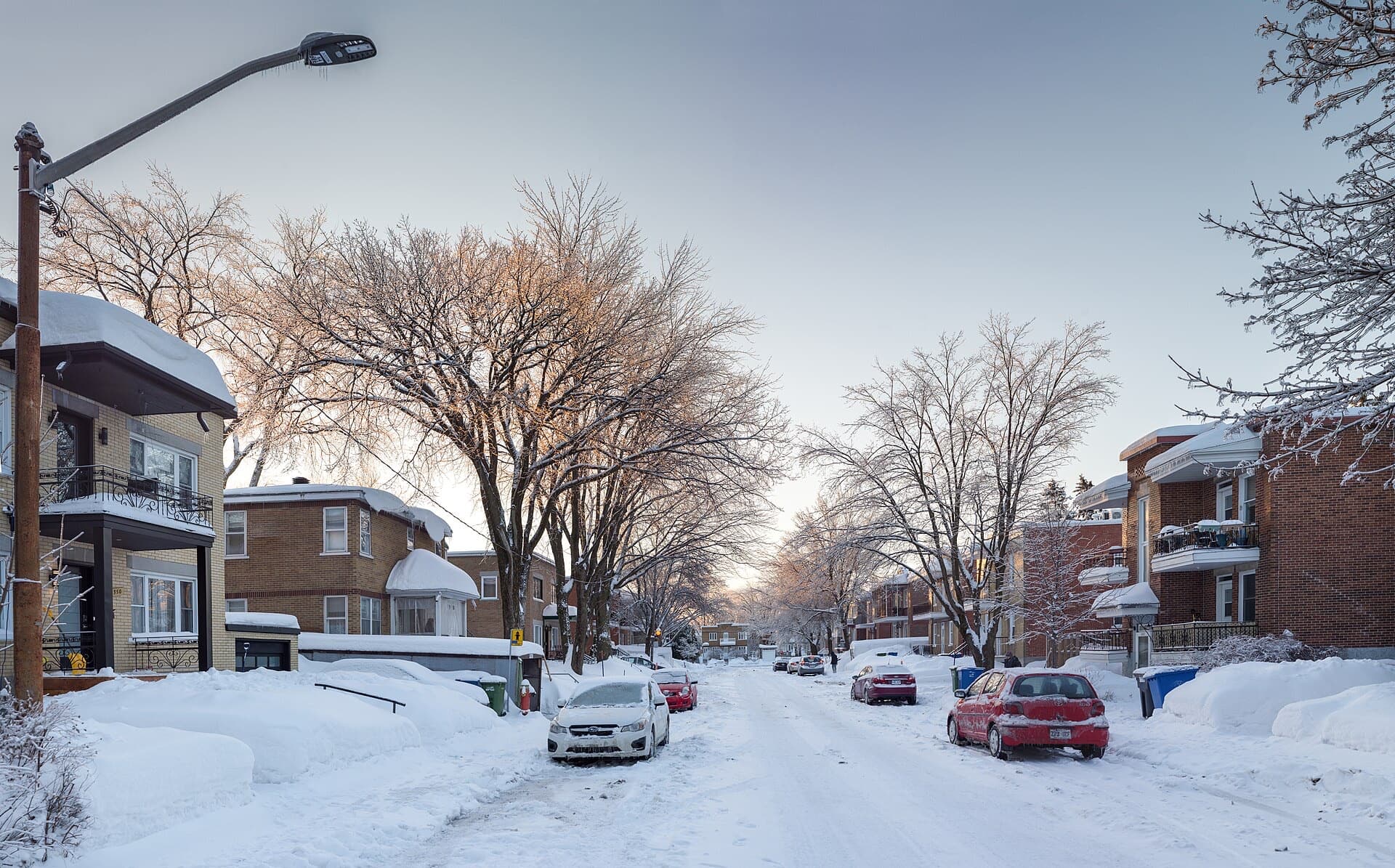A snow-piled residential street in Québec after a storm