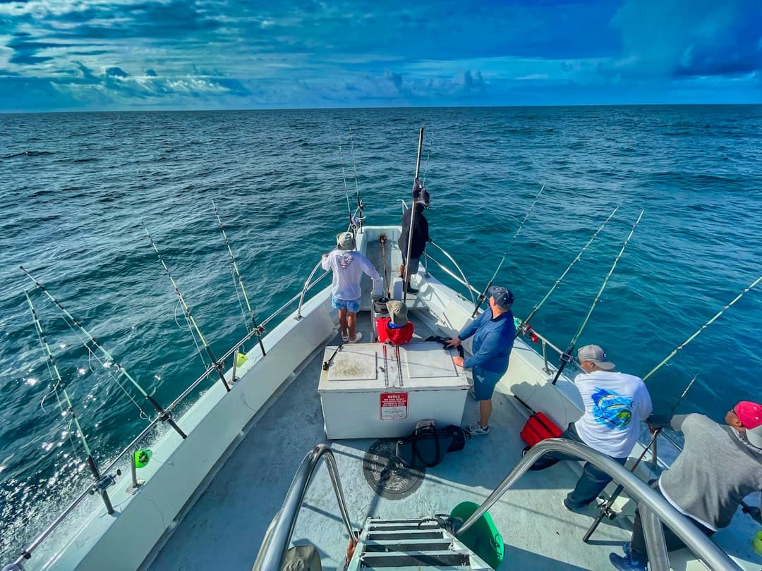 A sport-fishing boat heading out on blue Pacific water