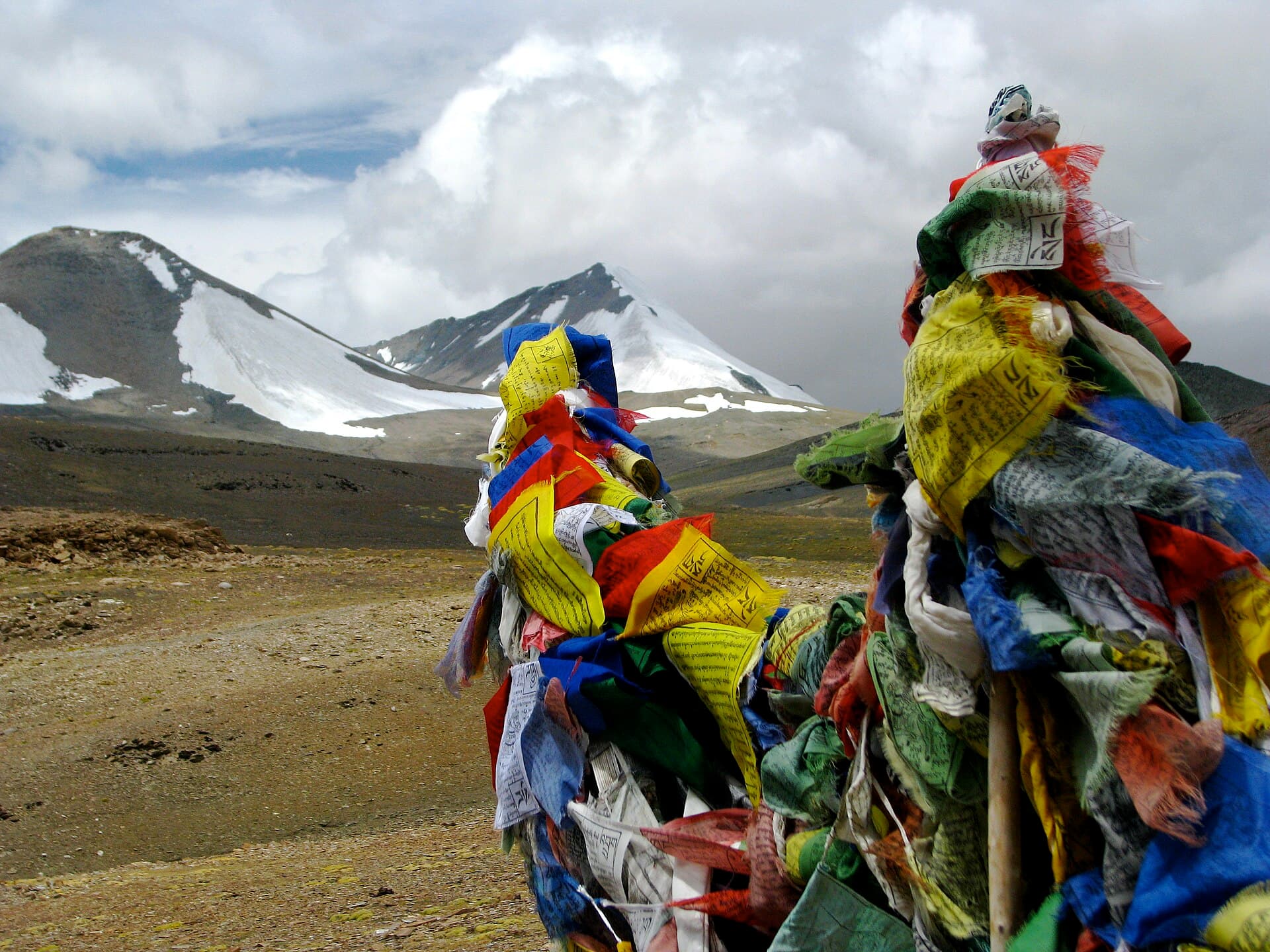 Prayer flags strung above a high Himalayan pass