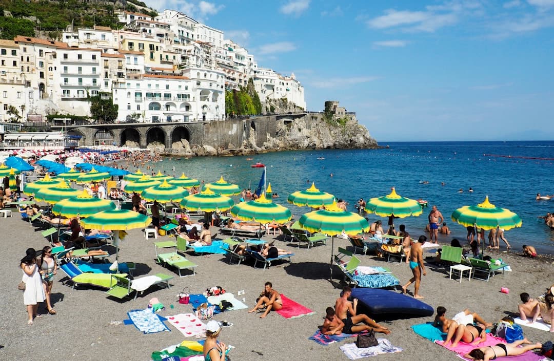 Striped umbrellas lining an Amalfi Coast beach