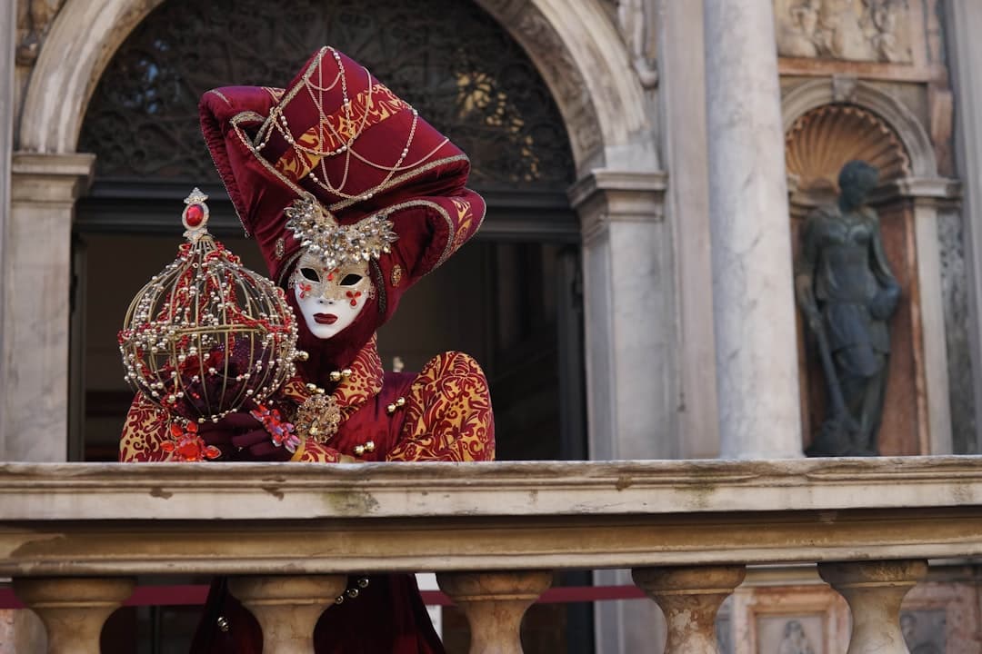 A gilded Venetian carnival mask in costume