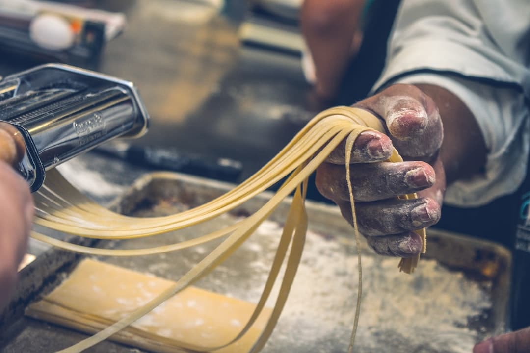 Flour-dusted hands shaping fresh pasta