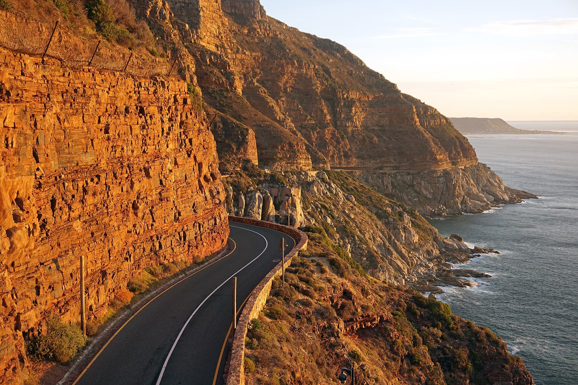 Chapman's Peak Drive carved into the cliffs at golden hour