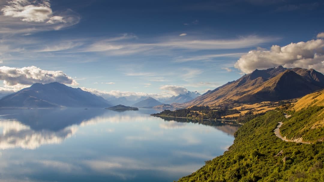 Lake Wakatipu stretching toward Glenorchy beneath golden mountains