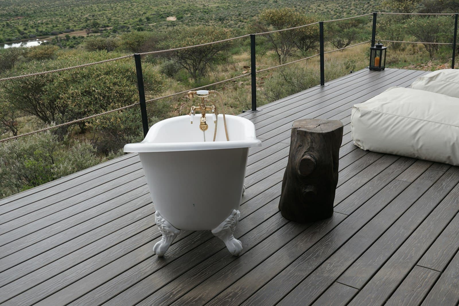 A clawfoot bath on a private deck overlooking the savanna