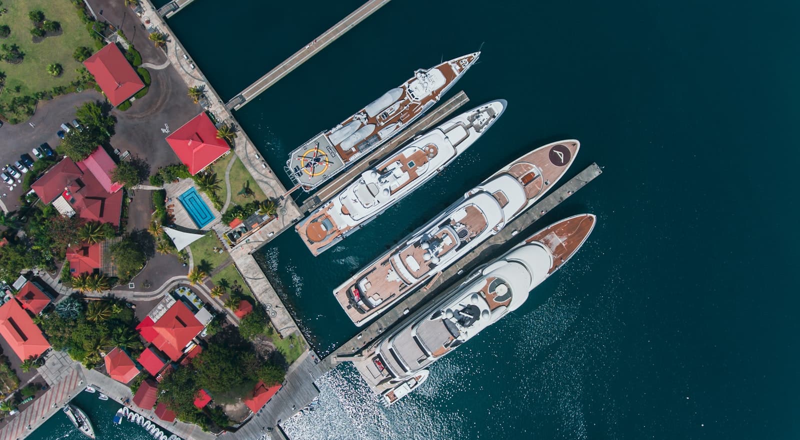 Four superyachts moored side by side, seen from above